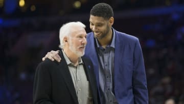 Dec 7, 2015; Philadelphia, PA, USA; Scratched San Antonio Spurs center Tim Duncan (R) dressed in plain clothes talks with head coach Gregg Popovich during the first quarter at Wells Fargo Center. Mandatory Credit: Bill Streicher-USA TODAY Sports