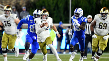 Duke football defenders try and tackle Ian Book. (Photo by Grant Halverson/Getty Images)