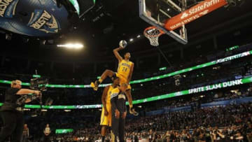Feb 25, 2012; Orlando, FL, USA; Paul George of the Indiana Pacers completes a dunk as he jumps over Roy Hibbert and Dahntay Jones at the 2012 NBA All-Star Slam Dunk Contest at the Amway Center. Mandatory Credit: Bob Donnan-USA TODAY Sports
