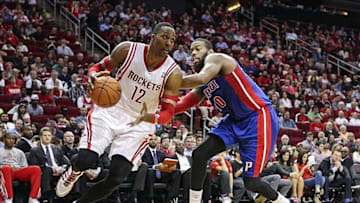 Mar 1, 2014; Houston, TX, USA; Houston Rockets center Dwight Howard (12) drives the ball during the second quarter as Detroit Pistons power forward Greg Monroe (10) defends at Toyota Center. Mandatory Credit: Troy Taormina-USA TODAY Sports