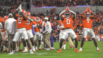 Nov 19, 2022; Clemson, South Carolina, USA; Clemson defensive end K.J. Henry (5), left, linebacker Barrett Carter (0), and defensive end Justin Mascoll (7) dance while signaling safety after sacking Miami quarterback Jacurri Brown (11) in the end zone during the third quarter at Memorial Stadium in Clemson, South Carolina at Memorial Stadium. Mandatory Credit: Ken Ruinard-USA TODAY Sports