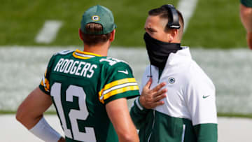 Sep 20, 2020; Green Bay, Wisconsin, USA; Green Bay Packers quarterback Aaron Rodgers (12) talks with head coach Matt LaFleur during the third quarter of the game against the Detroit Lions at Lambeau Field. Mandatory Credit: Jeff Hanisch-USA TODAY Sports