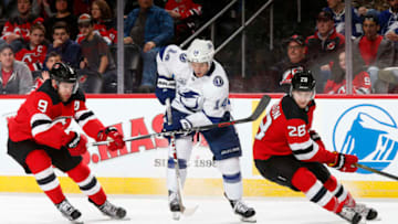 NEWARK, NJ - MARCH 24: Chris Kunitz #14 of the Tampa Bay Lightning battles for the puck between Damon Severson #28 of the New Jersey Devils and Taylor Hall #9 of the New Jersey Devils during the third period at the Prudential Center on March 24, 2018 in Newark, New Jersey. The Devils won 2-1. (Photo by Adam Hunger/Getty Images)