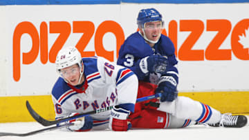 TORONTO, CANADA - JANUARY 25: Jimmy Vesey #26 of the New York Rangers collides with Justin Holl #3 of the Toronto Maple Leafs during an NHL game at Scotiabank Arena on January 25, 2023 in Toronto, Ontario, Canada. The Maple Leafs defeated the Rangers 3-2 in overtime. (Photo by Claus Andersen/Getty Images)