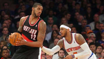 Feb 5, 2014; New York, NY, USA; Portland Trailblazers power forward LaMarcus Aldridge (12) controls the ball against New York Knicks small forward Carmelo Anthony (7) during the fourth quarter of a game at Madison Square Garden. The Trailblazers defeated the Knicks 94-90. Mandatory Credit: Brad Penner-USA TODAY Sports