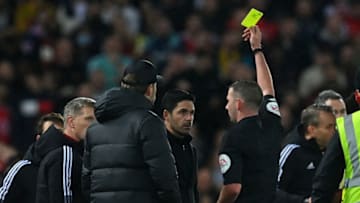 Arsenal's Spanish manager Mikel Arteta (C) and Liverpool's German manager Jurgen Klopp (centre left) are booked by English referee Michael Oliver after a clash on the touchline during the English Premier League football match between Liverpool and Arsenal at Anfield in Liverpool, north west England on November 20, 2021. - - RESTRICTED TO EDITORIAL USE. No use with unauthorized audio, video, data, fixture lists, club/league logos or 'live' services. Online in-match use limited to 120 images. An additional 40 images may be used in extra time. No video emulation. Social media in-match use limited to 120 images. An additional 40 images may be used in extra time. No use in betting publications, games or single club/league/player publications. (Photo by Paul ELLIS / AFP) / RESTRICTED TO EDITORIAL USE. No use with unauthorized audio, video, data, fixture lists, club/league logos or 'live' services. Online in-match use limited to 120 images. An additional 40 images may be used in extra time. No video emulation. Social media in-match use limited to 120 images. An additional 40 images may be used in extra time. No use in betting publications, games or single club/league/player publications. / RESTRICTED TO EDITORIAL USE. No use with unauthorized audio, video, data, fixture lists, club/league logos or 'live' services. Online in-match use limited to 120 images. An additional 40 images may be used in extra time. No video emulation. Social media in-match use limited to 120 images. An additional 40 images may be used in extra time. No use in betting publications, games or single club/league/player publications. (Photo by PAUL ELLIS/AFP via Getty Images)