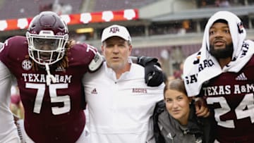 COLLEGE STATION, TEXAS - SEPTEMBER 03: Kam Dewberry #75 of the Texas A&M Aggies stands with Head Coach Jimbo Fisher following their 31-0 win over the Sam Houston State Bearkats at Kyle Field on September 03, 2022 in College Station, Texas. (Photo by Carmen Mandato/Getty Images)