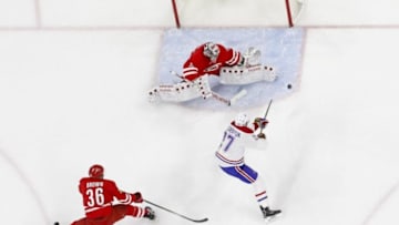 Apr 7, 2016; Raleigh, NC, USA; Carolina Hurricanes goalie Cam Ward (30) shoots the puck past Montreal Canadiens forward Alex Galchenyuk (27) during the first period at PNC Arena. The Canadiens won 4-2. Mandatory Credit: James Guillory-USA TODAY Sports
