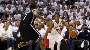Apr 22, 2014; Toronto, Ontario, CAN; Toronto Raptors guard DeMar DeRozan (10) tries to get around Brooklyn Nets guard Joe Johnson (7) in game two during the first round of the 2014 NBA Playoffs at Air Canada Centre. Toronto defeated Brooklyn 100-95. Mandatory Credit: John E. Sokolowski-USA TODAY Sports