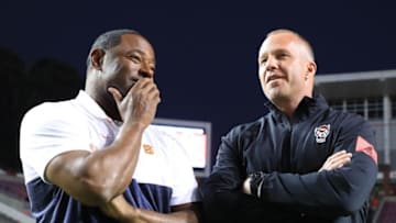RALEIGH, NORTH CAROLINA - OCTOBER 10: (L-R) Head coach Dino Babers of the Syracuse Orange talks to head coach Dave Doeren of the North Carolina State Wolfpack before their game at Carter Finley Stadium on October 10, 2019 in Raleigh, North Carolina. (Photo by Streeter Lecka/Getty Images)