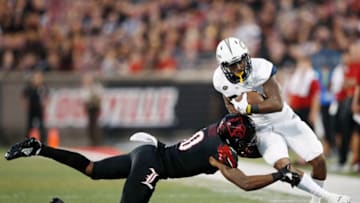 LOUISVILLE, KY - OCTOBER 05: Rodjay Burns #10 of the Louisville Cardinals makes a tackle near the sideline against Clinton Lynch #22 of the Georgia Tech Yellow Jackets in the first half of the game at Cardinal Stadium on October 5, 2018 in Louisville, Kentucky. (Photo by Joe Robbins/Getty Images)