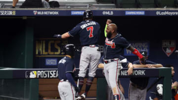ARLINGTON, TEXAS - OCTOBER 18: Dansby Swanson #7 of the Atlanta Braves is congratulated by Marcell Ozuna #20 after hitting a solo home run against the Los Angeles Dodgers during the second inning in Game Seven of the National League Championship Series at Globe Life Field on October 18, 2020 in Arlington, Texas. (Photo by Tom Pennington/Getty Images)