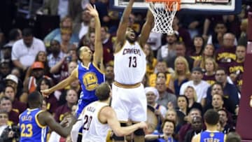 Jun 16, 2015; Cleveland, OH, USA; Cleveland Cavaliers center Tristan Thompson (13) dunks against Golden State Warriors guard Shaun Livingston (34) during the first quarter of game six of the NBA Finals at Quicken Loans Arena. Mandatory Credit: David Richard-USA TODAY Sports