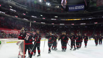 Mar 11, 2021; Raleigh, North Carolina, USA; Carolina Hurricanes players celebrate after defeating the Nashville Predators at PNC Arena. Mandatory Credit: James Guillory-USA TODAY Sports