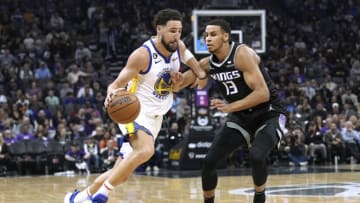 SACRAMENTO, CALIFORNIA - APRIL 07: Klay Thompson #11 of the Golden State Warriors looks to drive past Keegan Murray #13 of the Sacramento Kings during the first quarter at Golden 1 Center on April 07, 2023 in Sacramento, California. NOTE TO USER: User expressly acknowledges and agrees that, by downloading and or using this photograph, User is consenting to the terms and conditions of the Getty Images License Agreement. (Photo by Thearon W. Henderson/Getty Images)