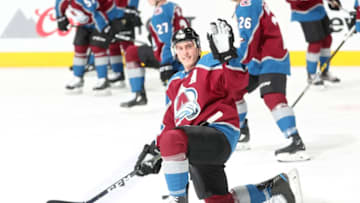 DENVER, CO - MARCH 17: Tyson Barrie #4 of the Colorado Avalanche waves to a fan during warm ups prior to the game against the New Jersey Devils at the Pepsi Center on March 17, 2019 in Denver, Colorado. (Photo by Michael Martin/NHLI via Getty Images)