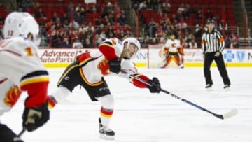 Jan 24, 2016; Raleigh, NC, USA; Calgary Flames forward Jiri Hudler (24) takes a shot against the Carolina Hurricanes at PNC Arena. The Hurricanes defeated the Flames 5-2. Mandatory Credit: James Guillory-USA TODAY Sports