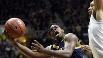 Jan 7, 2016; West Lafayette, IN, USA; Michigan Wolverines guard Derrick Walton Jr. (10) drives past Purdue Boilermakers center A.J. Hammons (20) in the first half at Mackey Arena. Mandatory Credit: Sandra Dukes-USA TODAY Sports