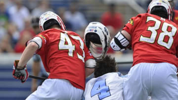 May 17, 2015; Annapolis, MD, USA; North Carolina Tar Heels attack Jimmy Bitter (4) looses his helmet as he collides into Maryland Terrapins defense Mac Pons (43) and midfielder Henry West (38) during the first half at Navy Marine Corps Memorial Stadium. Mandatory Credit: Tommy Gilligan-USA TODAY Sports