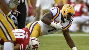 Sep 3, 2016; Green Bay, WI, USA; LSU running back Leonard Fournette (right) tries to break a tackle from Wisconsin linebacker Jack Cichy in the 2nd quarter at Lambeau Field. Mandatory Credit: Benny Sieu-USA TODAY Sports