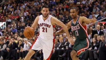 Apr 14, 2014; Toronto, Ontario, CAN; Toronto Raptors guard Greivis Vasquez (21) carries the ball past Milwaukee Bucks guard Ramon Sessions (13) during the first half at the Air Canada Centre. Mandatory Credit: John E. Sokolowski-USA TODAY Sports