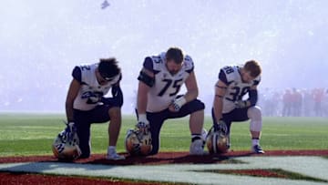PASADENA, CA - JANUARY 01: Aaron Fuller #2 of the Washington Huskies, Jesse Sosebee #75 of the Washington Huskies and Zechariah Brown #38 of the Washington Huskies take a knee during the National Anthem during the Rose Bowl Game presented by Northwestern Mutual at the Rose Bowl on January 1, 2019 in Pasadena, California. (Photo by Kevork Djansezian/Getty Images)