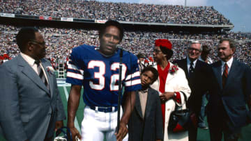 ORCHARD PARK, NY - SEPTEMBER 14: O.J. Simpson, professional football player with the Buffalo Bills, is inducted into the Wall of Fame in Rich Stadium on September 14, 1980. Simpson is accompanied by his parents, his son, Jason, and Ralph Wilson, owner of the Buffalo Bills. (Photo by Ross Lewis/Getty Images)