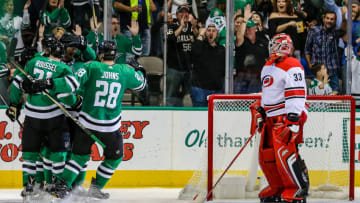 DALLAS, TX - OCTOBER 21: Carolina Hurricanes goalie Scott Darling (33) watches the Dallas Stars players celebrate a goal during the game between the Dallas Stars and the Carolina Hurricanes on October 21, 2017 at the American Airlines Center in Dallas Texas. Dallas defeats Carolina 4-3. (Photo by Matthew Pearce/Icon Sportswire via Getty Images)
