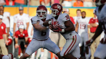 Dec 31, 2015; Miami Gardens, FL, USA;Oklahoma Sooners quarterback Baker Mayfield (6) hands the ball off to running back Samaje Perine (32) in the first quarter of the 2015 CFP Semifinal at the Orange Bowl at Sun Life Stadium. Mandatory Credit: Kim Klement-USA TODAY Sports