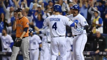 Oct 14, 2015; Kansas City, MO, USA; Kansas City Royals catcher Salvador Perez (13) and left fielder Alex Gordon (4) celebrate after scoring runs against Houston Astros pitcher Mike Fiers (54) in the fifth inning in game five of the ALDS at Kauffman Stadium. Mandatory Credit: Peter G. Aiken-USA TODAY Sports