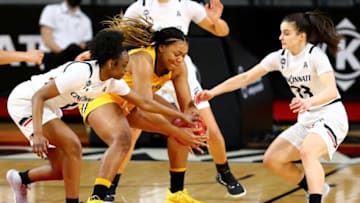 Cincinnati Bearcats guards Caitlyn Wilson and Sofia Gritzali compete for a loose ball. The Enquirer.