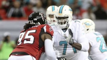 Aug 8, 2014; Atlanta, GA, USA; Miami Dolphins tackle Branden Albert (71) blocks Atlanta Falcons defensive tackle Jonathan Babineaux (95) in the first half of their game at Georgia Dome. Mandatory Credit: Jason Getz-USA TODAY Sports