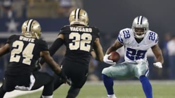 Sep 28, 2014; Arlington, TX, USA; Dallas Cowboys running back DeMarco Murray (29) runs with the ball against New Orleans Saints safety Kenny Vaccaro (32) and cornerback Corey White (24) at AT&T Stadium. Mandatory Credit: Matthew Emmons-USA TODAY Sports