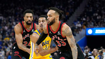SAN FRANCISCO, CALIFORNIA - NOVEMBER 21: Gary Trent Jr. #33 of the Toronto Raptors drives towards the basket on Jordan Poole #3 of the Golden State Warriors during the first half of an NBA basketball game at Chase Center on November 21, 2021 in San Francisco, California. NOTE TO USER: User expressly acknowledges and agrees that, by downloading and or using this photograph, User is consenting to the terms and conditions of the Getty Images License Agreement. (Photo by Thearon W. Henderson/Getty Images)