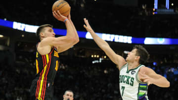 Mar 9, 2022; Milwaukee, Wisconsin, USA; Atlanta Hawks guard Bogdan Bogdanovic (13) puts up a shot against Milwaukee Bucks guard Grayson Allen (7) in the second half at Fiserv Forum. Mandatory Credit: Michael McLoone-USA TODAY Sports