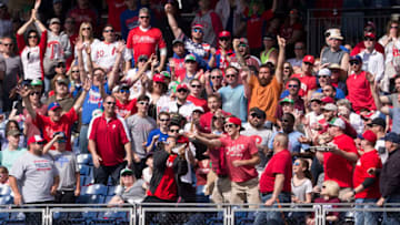 PHILADELPHIA, PA - APRIL 23: Fans try to catch the two run home run ball hit by Cesar Hernandez