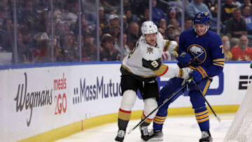 Mar 10, 2022; Buffalo, New York, USA; Vegas Golden Knights center Jack Eichel (9) and Buffalo Sabres right wing Tage Thompson (72) go after loose puck along the boards during the first period at KeyBank Center. Mandatory Credit: Timothy T. Ludwig-USA TODAY Sports