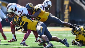 Oct 3, 2015; Columbia, MO, USA; Missouri Tigers defensive lineman Josh Moore (18) and Missouri Tigers linebacker Kentrell Brothers (10) tackle South Carolina Gamecocks quarterback Lorenzo Nunez (19) during the second half at Faurot Field. The Tigers won 24-10. Mandatory Credit: Jasen Vinlove-USA TODAY Sports
