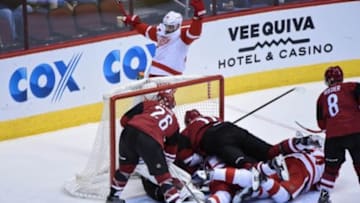 Jan 14, 2016; Glendale, AZ, USA; Detroit Red Wings center Gustav Nyquist (14) scores a goal as left wing Henrik Zetterberg (40) celebrates and Arizona Coyotes goalie Louis Domingue (35), center Martin Hanzal (11), defenseman Michael Stone (26) ad center Tobias Rieder (8) react during the third period at Gila River Arena. Mandatory Credit: Matt Kartozian-USA TODAY Sports