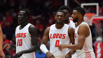ALBUQUERQUE, NEW MEXICO - FEBRUARY 29: JaQuan Lyle #5 (R) talks to Zane Martin #0 of the New Mexico Lobos as Makuach Maluach #10 stands on the court during their game against the Utah State Aggies at Dreamstyle Arena - The Pit on February 29, 2020 in Albuquerque, New Mexico. The Lobos defeated the Aggies 66-64. (Photo by Sam Wasson/Getty Images)