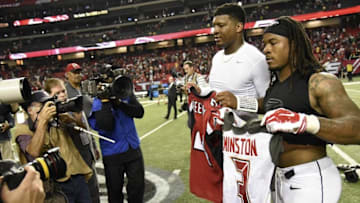 Nov 1, 2015; Atlanta, GA, USA; Tampa Bay Buccaneers quarterback Jameis Winston (3) (left) and Atlanta Falcons running back Devonta Freeman (24) who played together at Florida State exchange jerseys after the game at the Georgia Dome. The Buccaneers defeated the Falcons 23-20 in over time. Mandatory Credit: Dale Zanine-USA TODAY Sports
