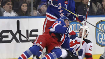 NEW YORK, NEW YORK - JANUARY 09: Mika Zibanejad #93 of the New York Rangers checks Nico Hischier #13 of the New Jersey Devils during the first period at Madison Square Garden on January 09, 2020 in New York City. (Photo by Bruce Bennett/Getty Images)