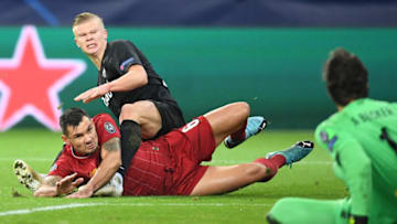 Erling Haaland and Dejan Lovren fight for the ball (Photo by JOE KLAMAR/AFP via Getty Images)