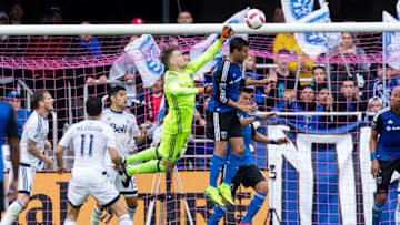 Oct 16, 2016; San Jose, CA, USA; Vancouver Whitecaps goalkeeper Paolo Tornaghi (70) punches the ball over San Jose Earthquakes forward Chris Wondolowski (8) in the first half at Avaya Stadium. Mandatory Credit: John Hefti-USA TODAY Sports