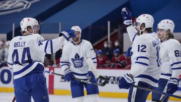 MONTREAL, QC - MAY 03: Morgan Rielly #44 of the Toronto Maple Leafs celebrates his first period goal against the Montreal Canadiens with teammate Alex Galchenyuk #12 at the Bell Centre on May 3, 2021 in Montreal, Canada. (Photo by Minas Panagiotakis/Getty Images)