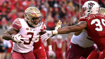 RALEIGH, NC - NOVEMBER 03: Cam Akers #3 of the Florida State Seminoles runs with the ball against James Smith-Williams #39 of the North Carolina State Wolfpack at Carter-Finley Stadium on November 3, 2018 in Raleigh, North Carolina. (Photo by Lance King/Getty Images)