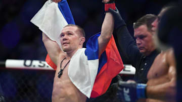 Dec 14, 2019; Las Vegas, NV, USA; Petr Yan (red gloves) reacts after defeating Urijah Faber (blue gloves) during UFC 245 at T-Mobile Arena. Mandatory Credit: Stephen R. Sylvanie-USA TODAY Sports