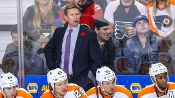 Nov 5, 2015; Calgary, Alberta, CAN; Philadelphia Flyers head coach Dave Hakstol (C) stand behind his bench against the Calgary Flames during the third period at Scotiabank Saddledome. The Flames won 2-1. Mandatory Credit: Sergei Belski-USA TODAY Sports