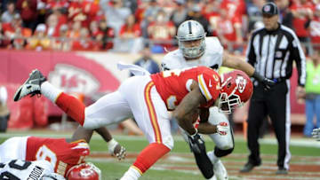 Dec 14, 2014; Kansas City, MO, USA; Kansas City Chiefs running back Knile Davis (34) scores a touchdown against the Oakland Raiders in the second half at Arrowhead Stadium. The Chiefs won 31-13. Mandatory Credit: John Rieger-USA TODAY Sports