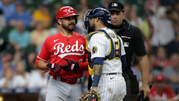 MILWAUKEE, WISCONSIN - JULY 11: Omar Narvaez #10 of the Milwaukee Brewers blocks Eugenio Suarez #7 of the Cincinnati Reds after being hit by a pitch in the ninth inning against the Milwaukee Brewers at American Family Field on July 11, 2021 in Milwaukee, Wisconsin. (Photo by John Fisher/Getty Images)